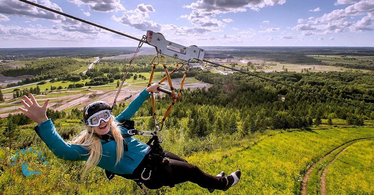 Rider safely approaching the end of a high-speed zipline